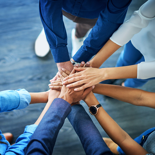 many hands in huddle